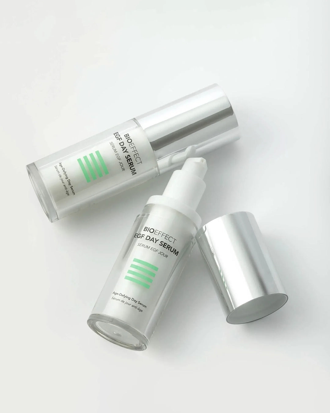 Two skincare serum bottles with droppers on a white background