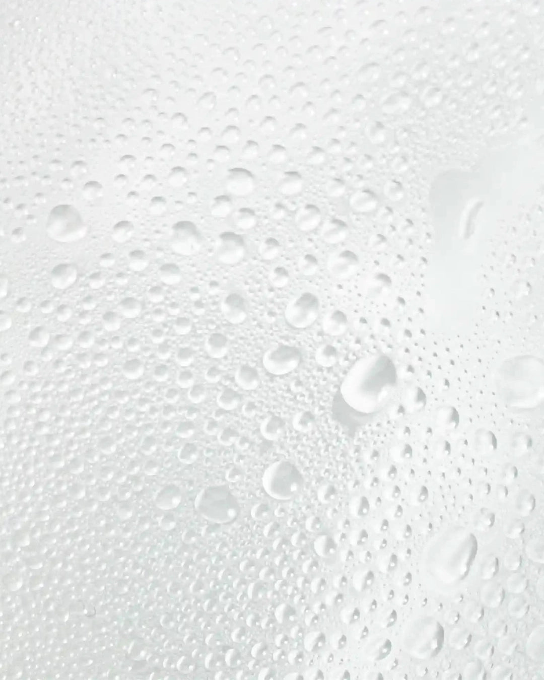 Close-up of water droplets on a textured glass surface