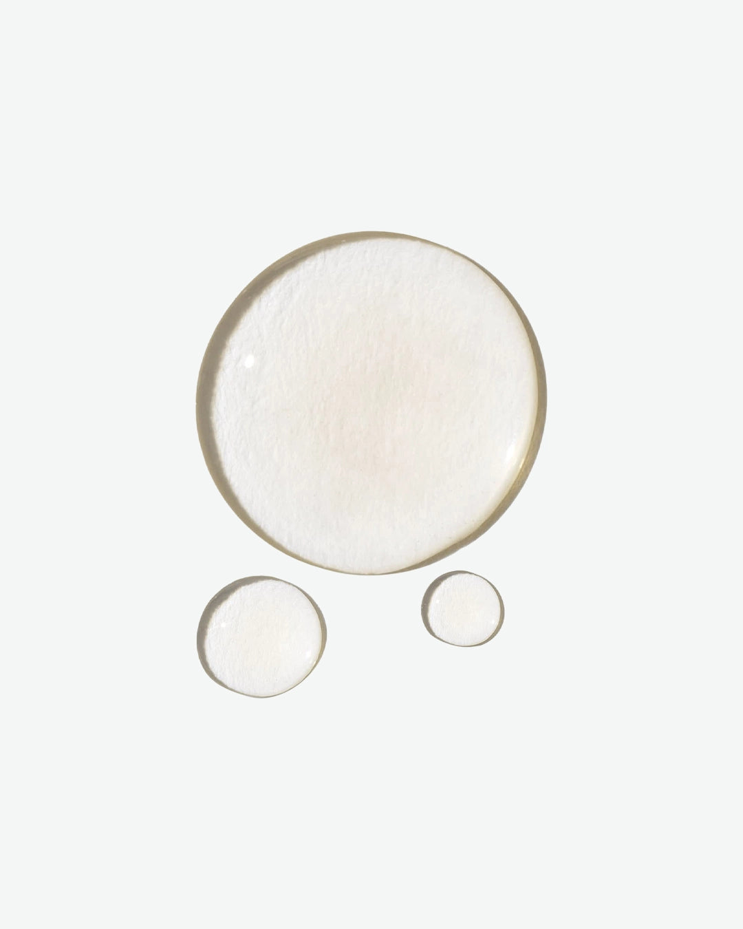 Three round light drops on a white background