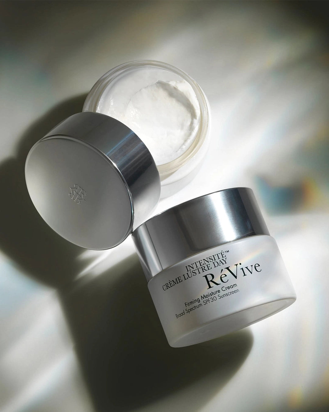 Revive cream jar with lid on a reflective surface