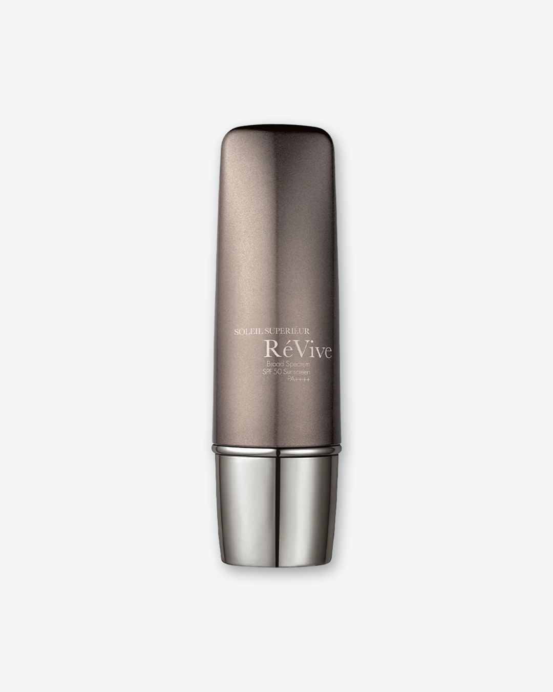 RéVive Soleil Supérieur Broad Spectrum SPF 50 Sunscreen PA++++ in a sleek, metallic bronze and silver pump bottle, isolated against a light grey background.