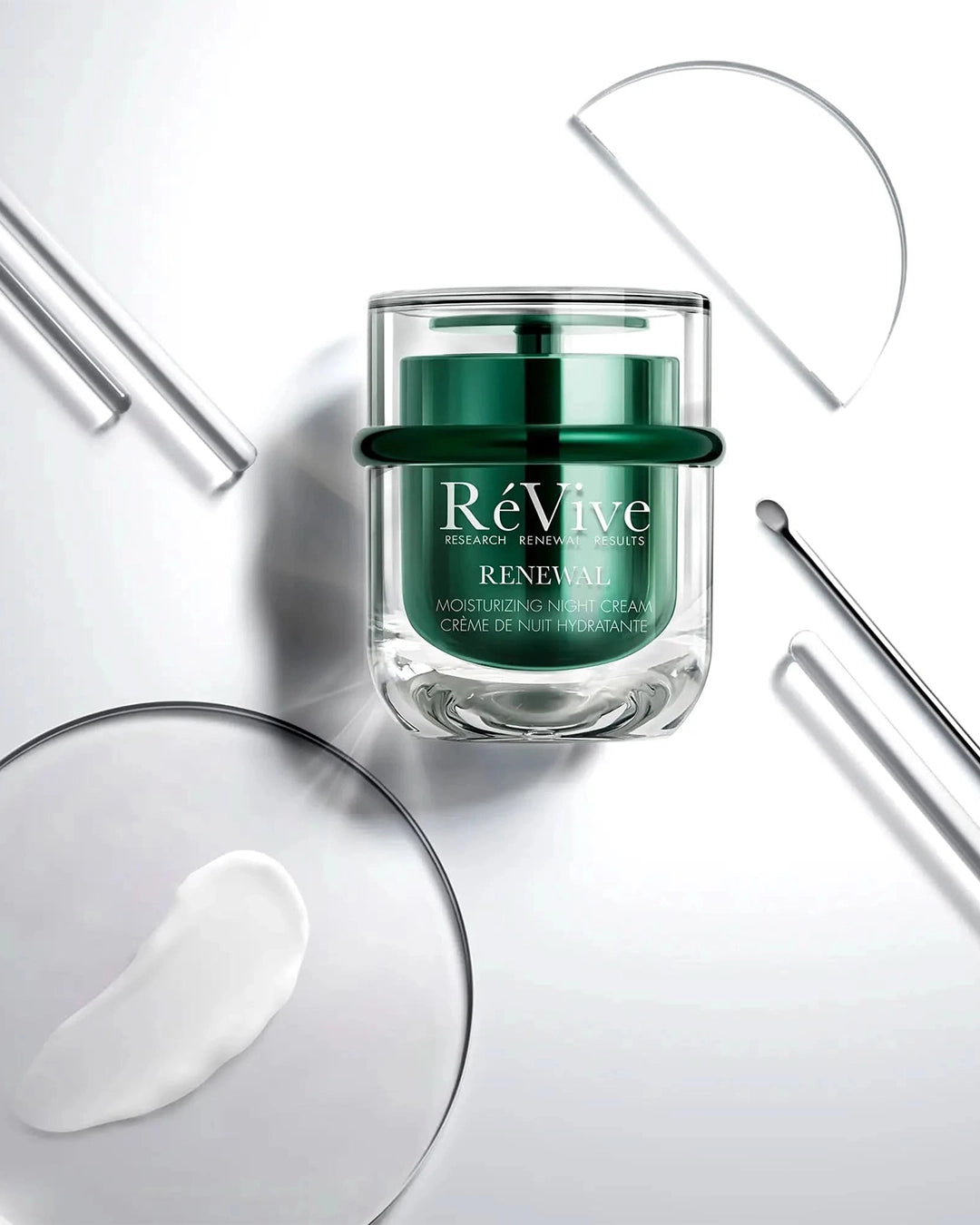 Green skincare cream jar labeled 'RéVive' on a white background