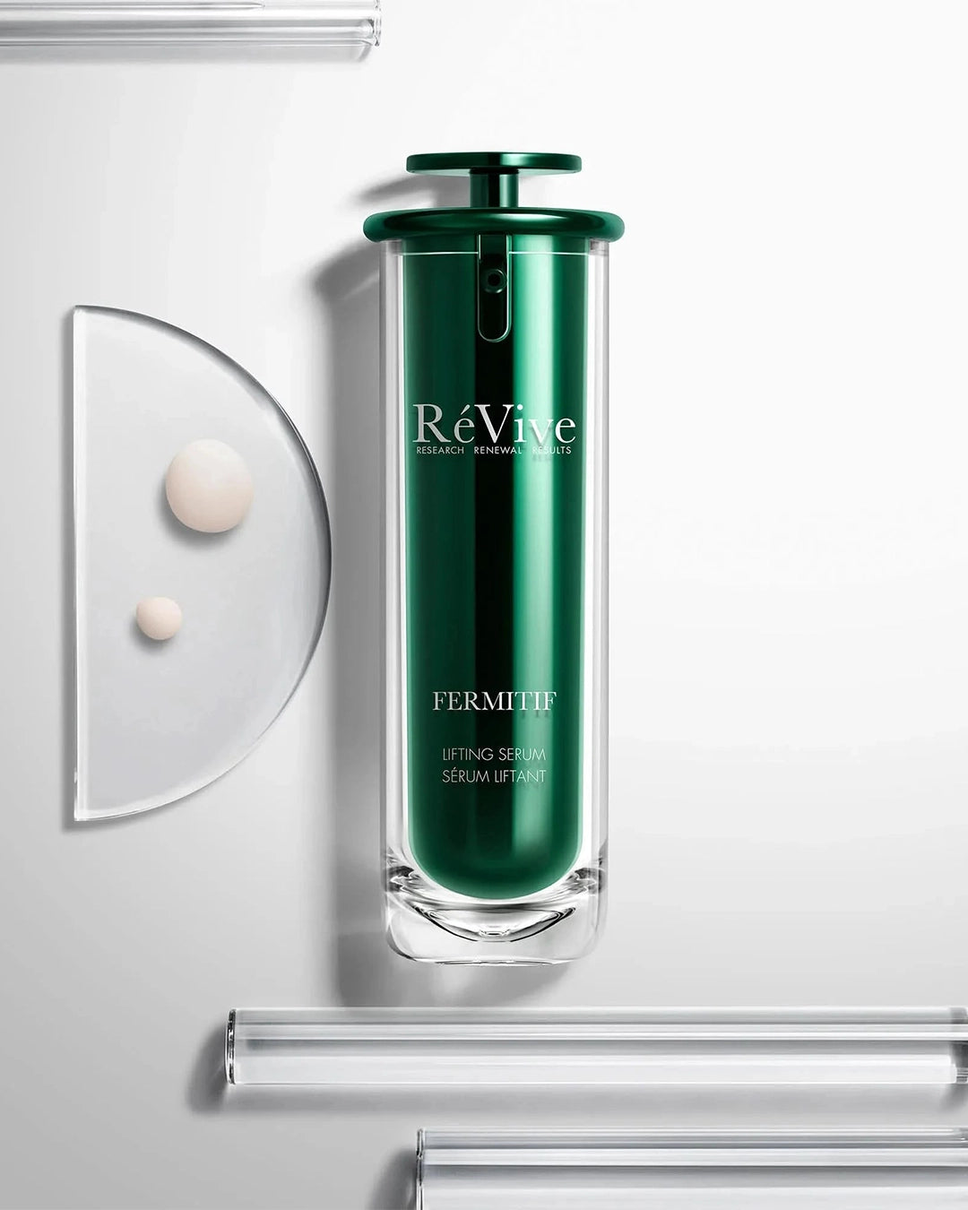 Green skincare serum bottle labeled 'Re Vive' on a white background