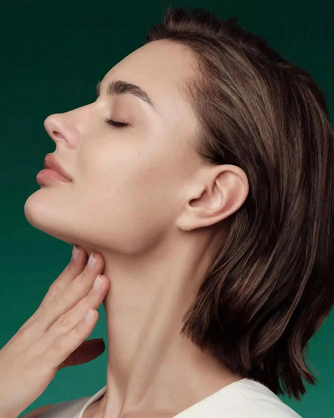 Woman with a close-up of her neck against a green background