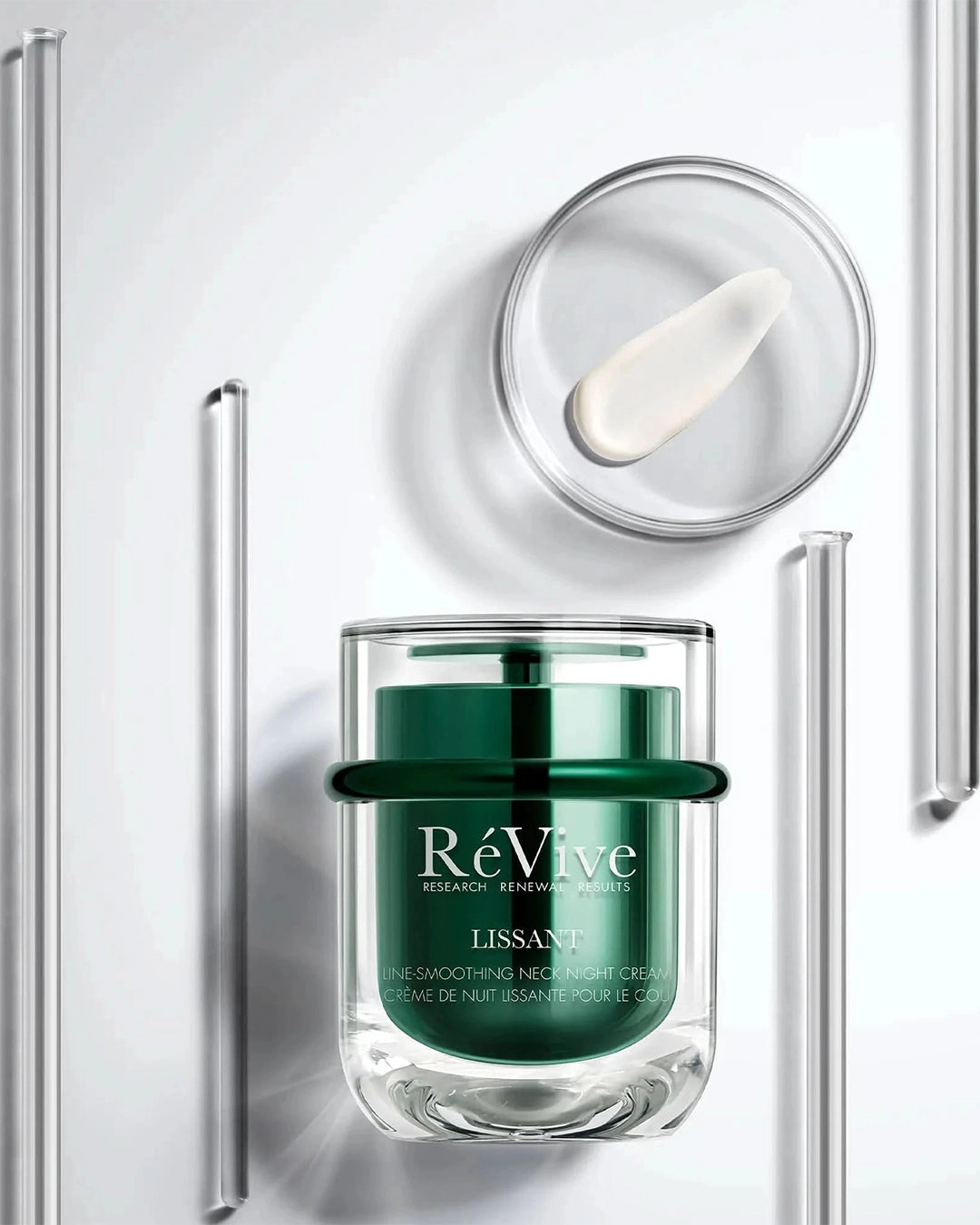 Green skincare cream jar with applicator on a white background, featuring the brand 'ReVive'.