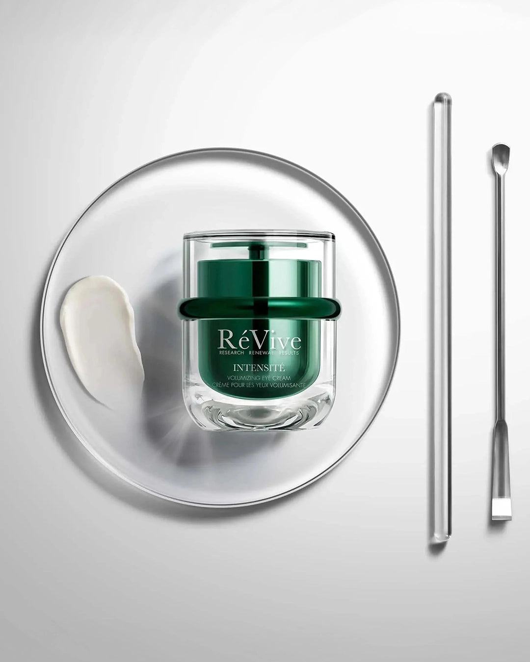ReVive skincare product with applicator on a white background