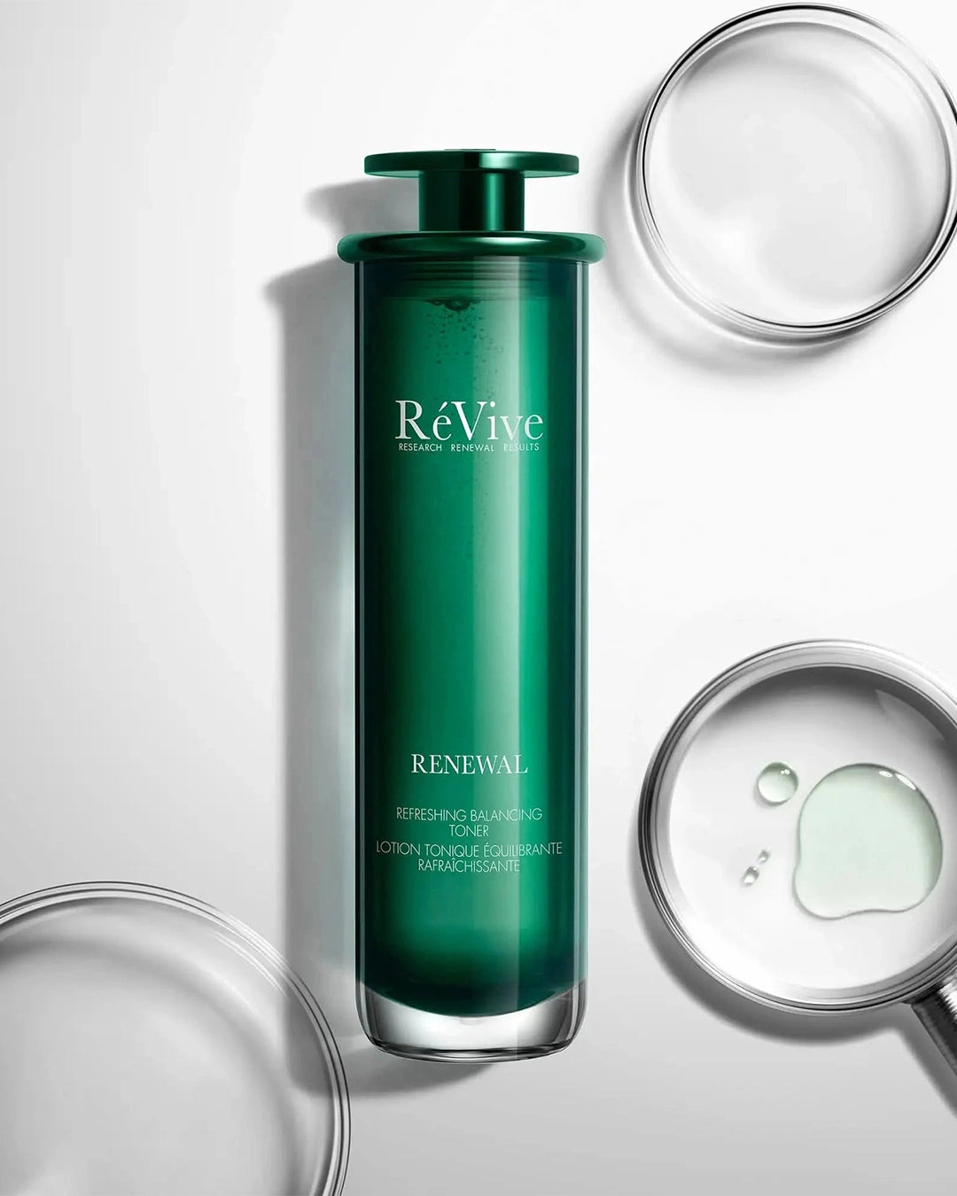 Green skincare bottle labeled 'RéVive' on a white background