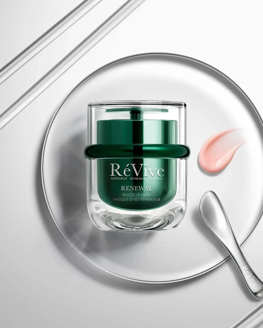 Revive skincare jar on a white background with a spoon and cream smear.
