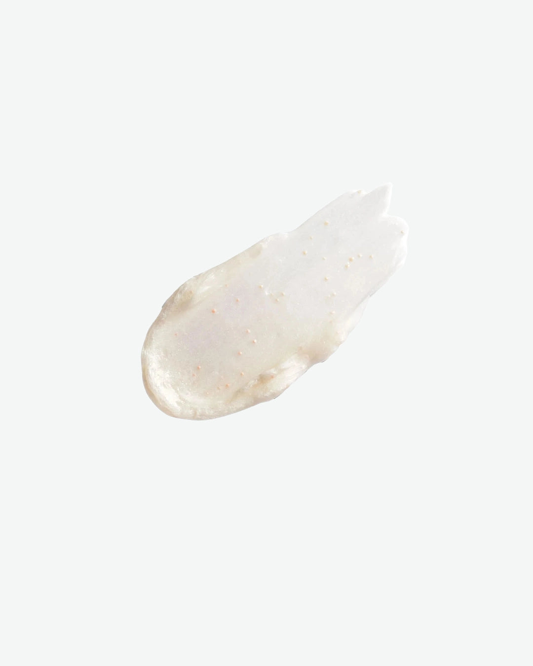 White cream droplet on a light beige background