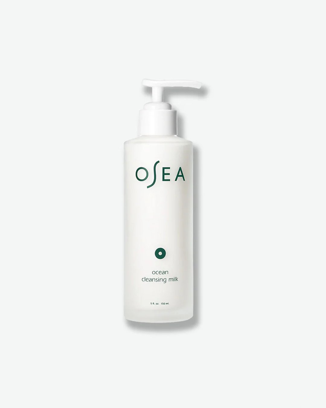 A vertical product shot of OSEA Ocean Cleansing Milk. The white, creamy cleanser is presented in a frosted glass bottle with a matching white pump mechanism, adorned with dark green branding and a solid circular dot icon.