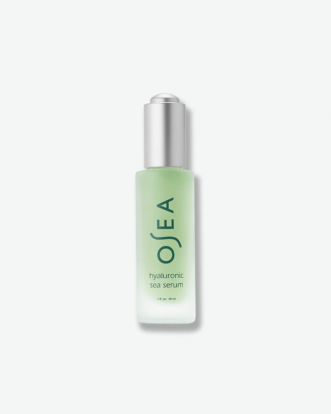 A vertical product shot of OSEA Hyaluronic Sea Serum in a 1 fl. oz. (30 ml) bottle. The pale seafoam-green serum is contained within a frosted glass bottle fitted with a metallic silver dropper cap. Minimalist dark green typography outlines the brand name and product description on the front.