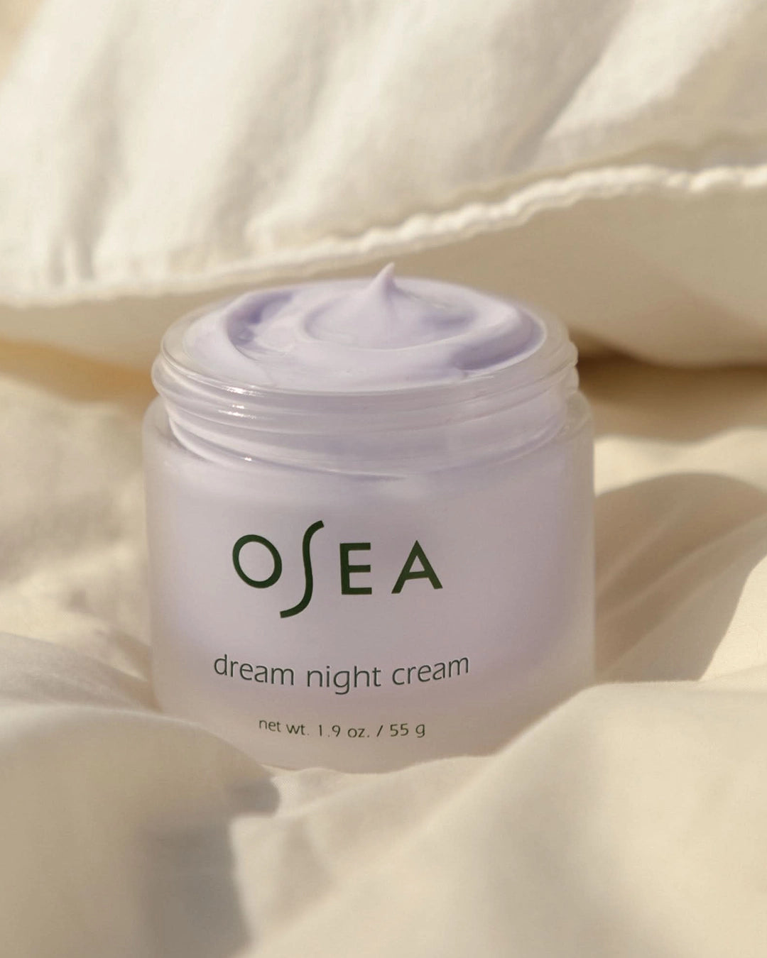 OSEA dream night cream jar on a soft beige background