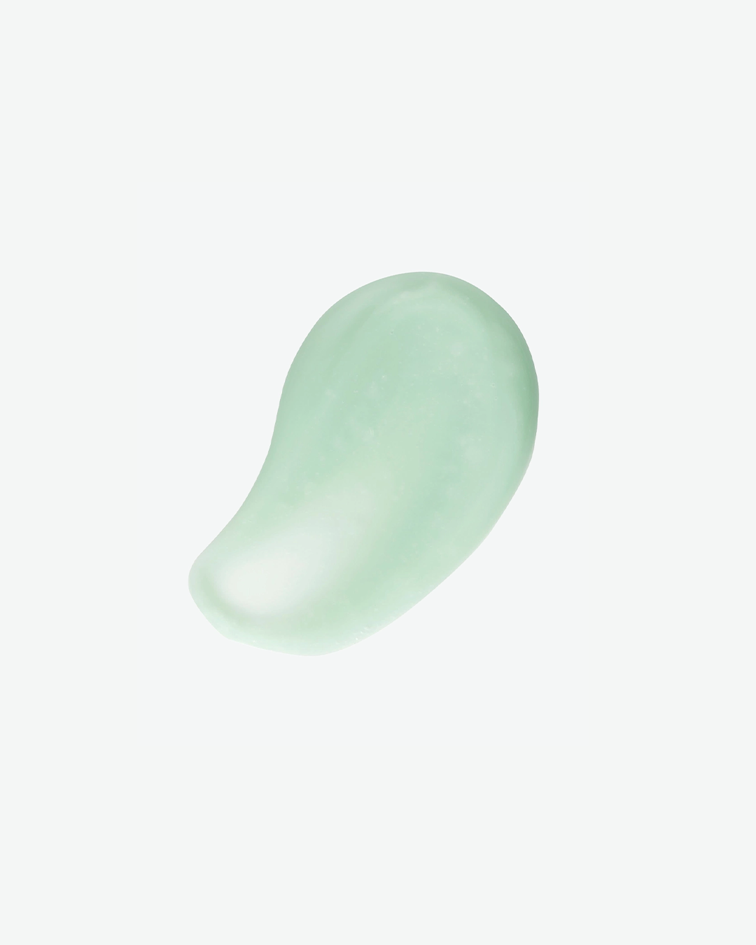 A top-down product texture shot featuring a smooth, teardrop-shaped dollop of translucent seafoam-green serum isolated against a solid white background.