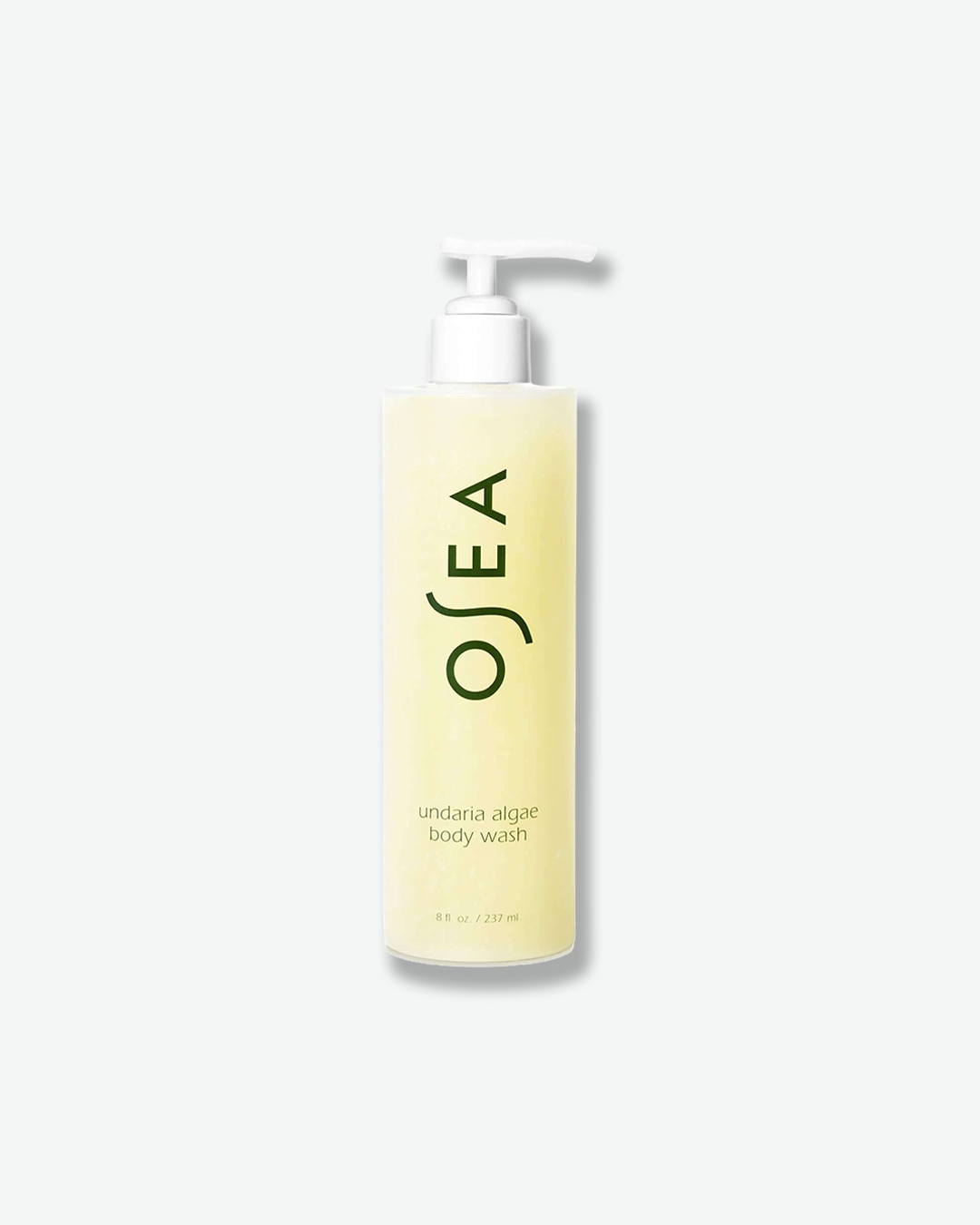 A vertical product shot of OSEA Undaria Algae Body Wash. The translucent, pale yellow body wash is housed in a tall, cylindrical frosted bottle topped with a white pump dispenser. The dark green OSEA brand logo is printed vertically in the center, with the product name and "8 fl. oz. / 237 ml" details positioned neatly below it.