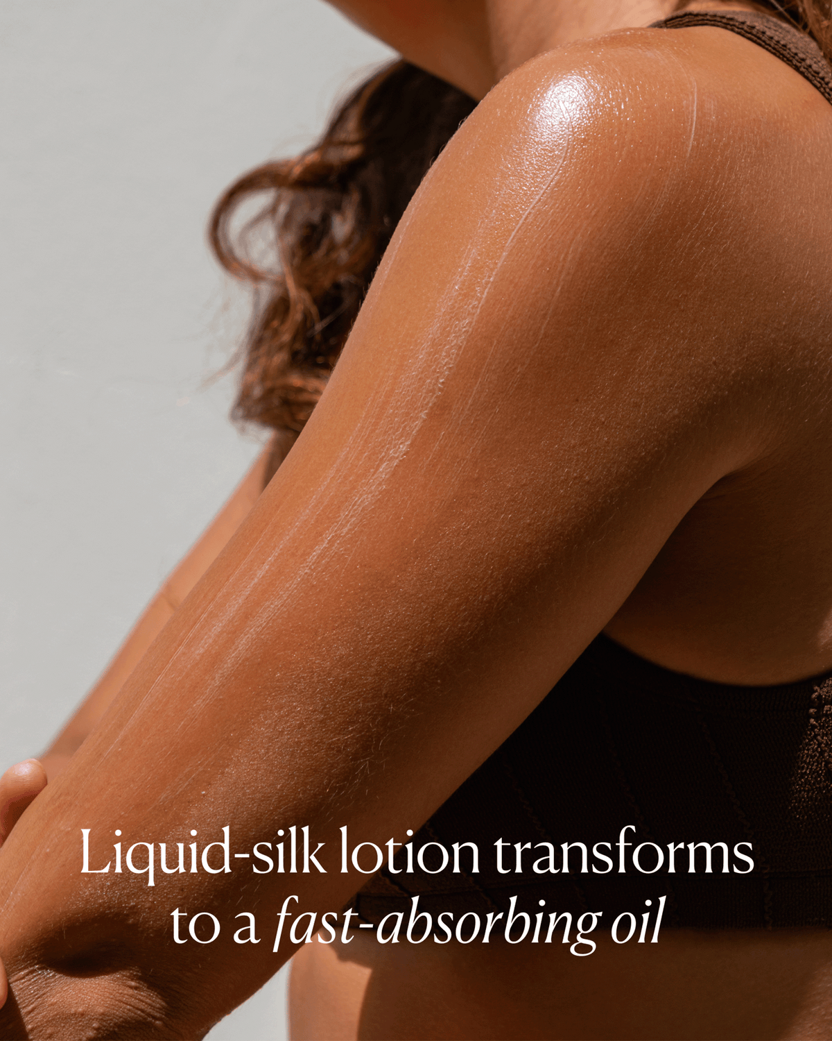 Close-up of moisturized glowing skin demonstrating OSEA’s liquid-silk lotion texture transforming into a fast-absorbing oil.