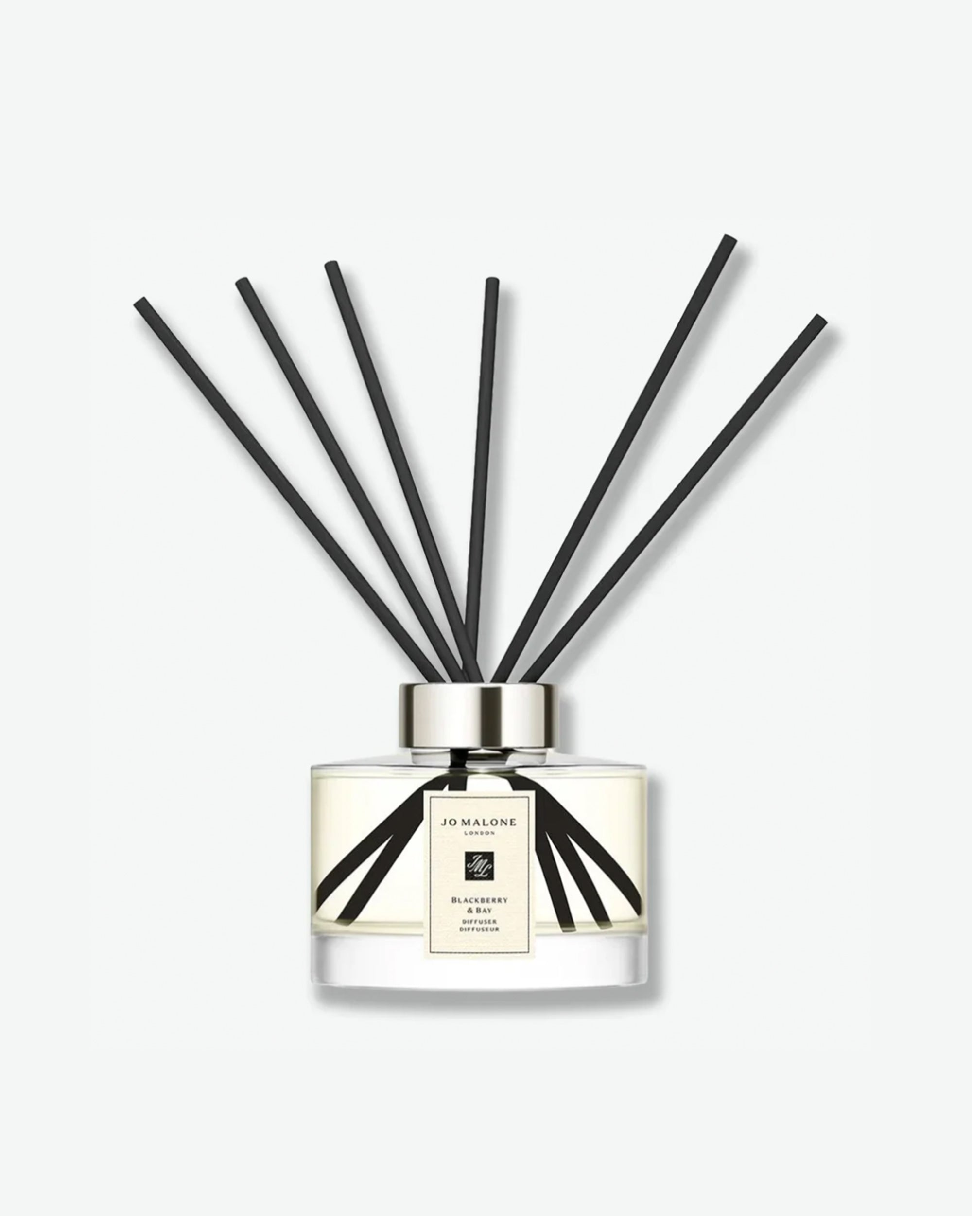 Jo Malone glass jar diffuser with black reeds on a white background