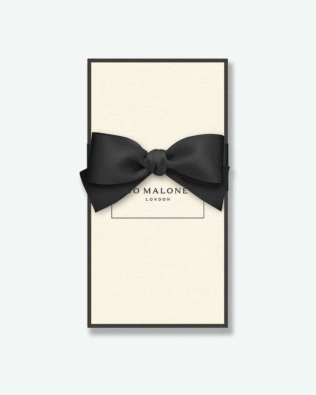 Black bow tie in a 'Jo Malone London' box on a white background