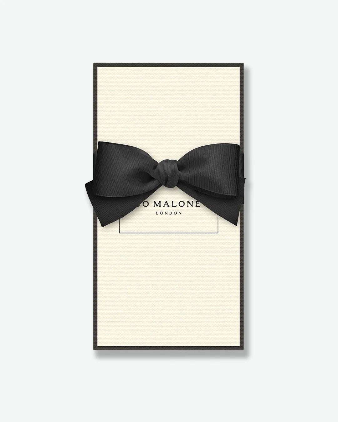 Black bow tie in a 'Jo Malone London' box on a white background