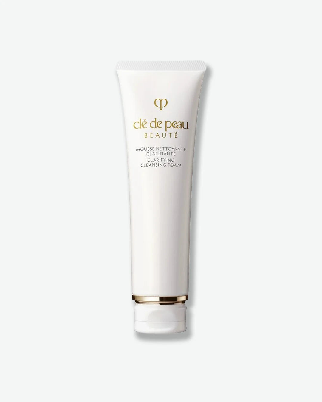 Tube of cle de peau beauty product on a white background