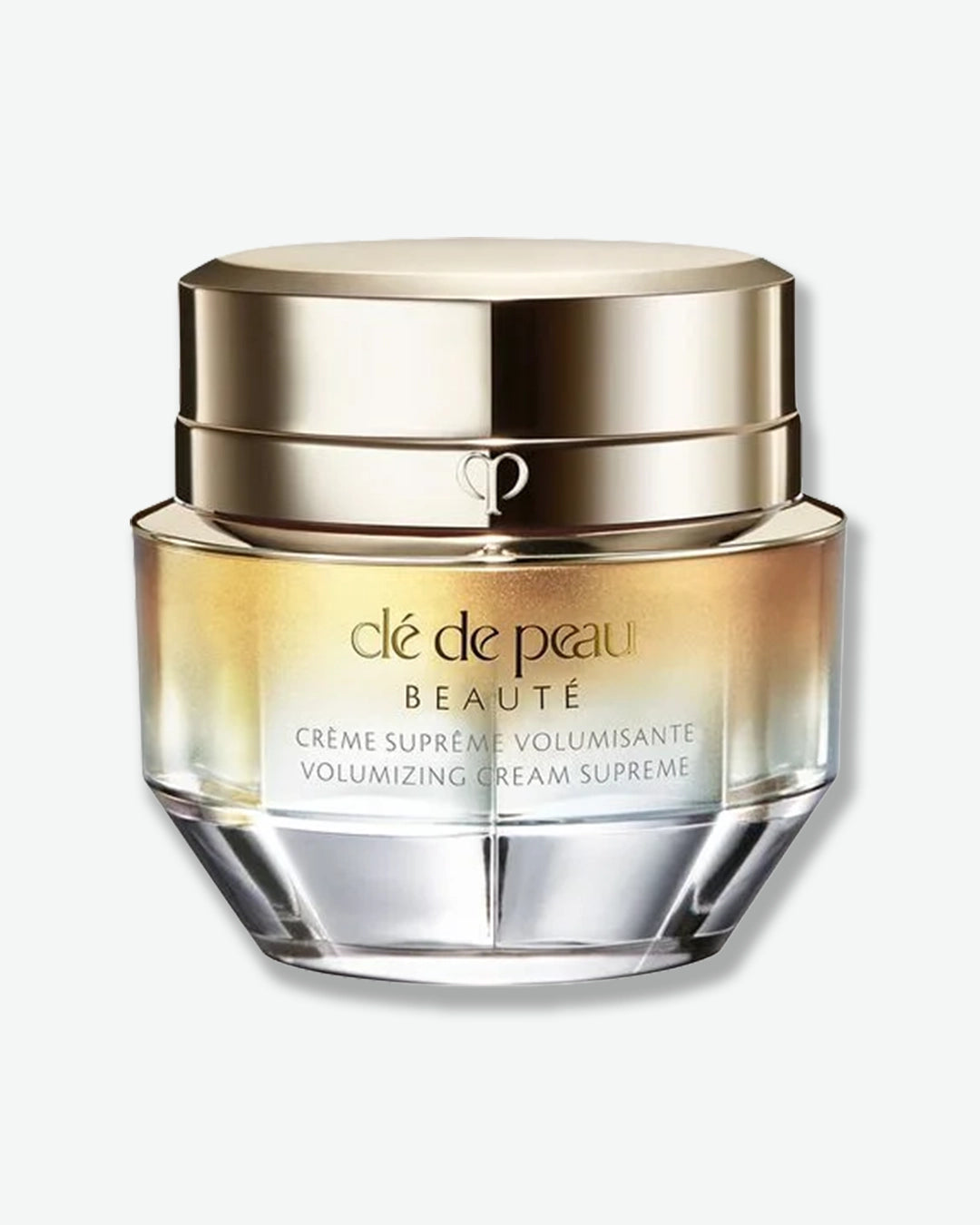 Clé de Peau beauty cream jar with a gold cap on a white background