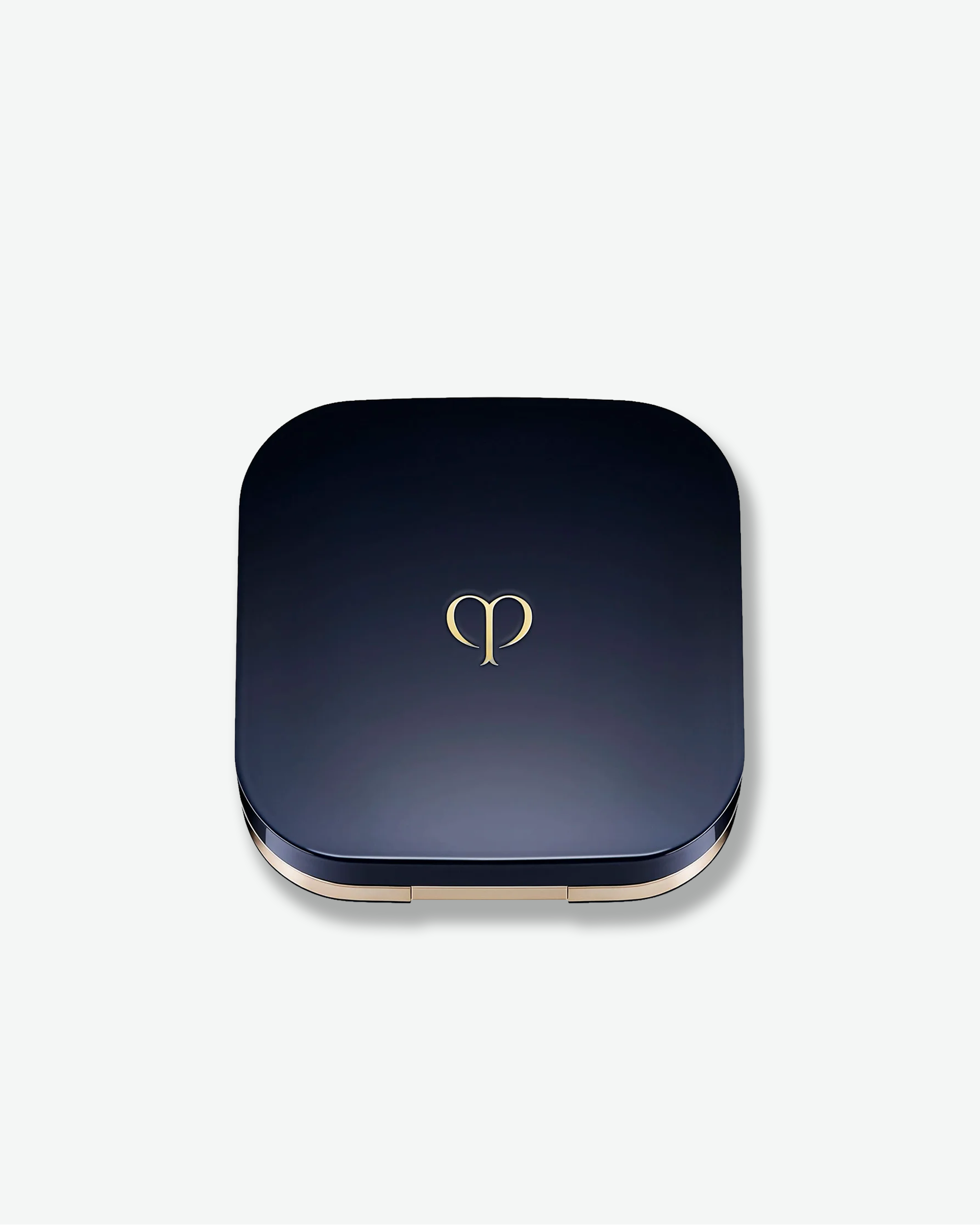 Blue compact powder case with a gold logo on a white background