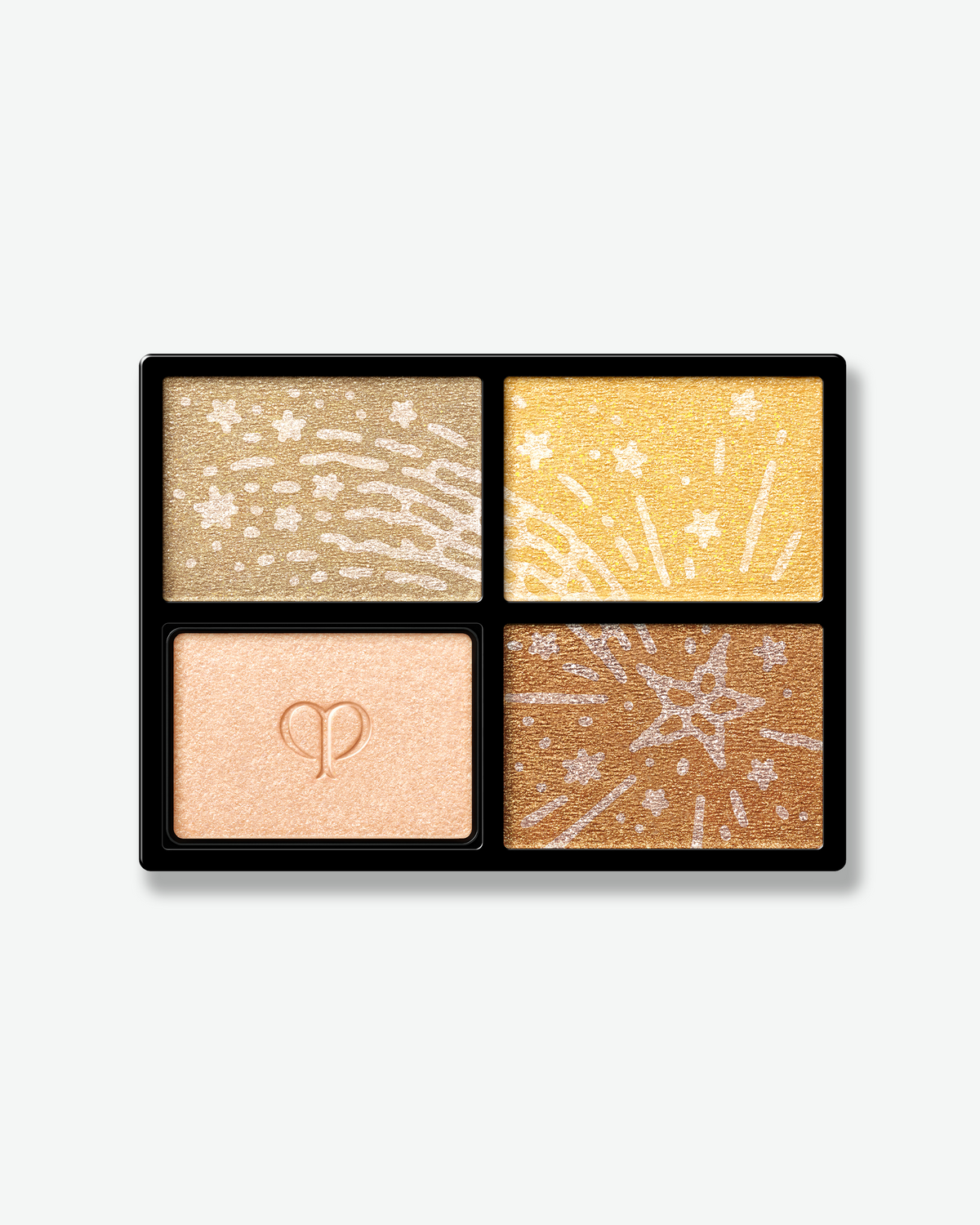 Close-up of Clé de Peau Beauté holiday eyeshadow quad featuring four luminous shades with intricate celestial designs.