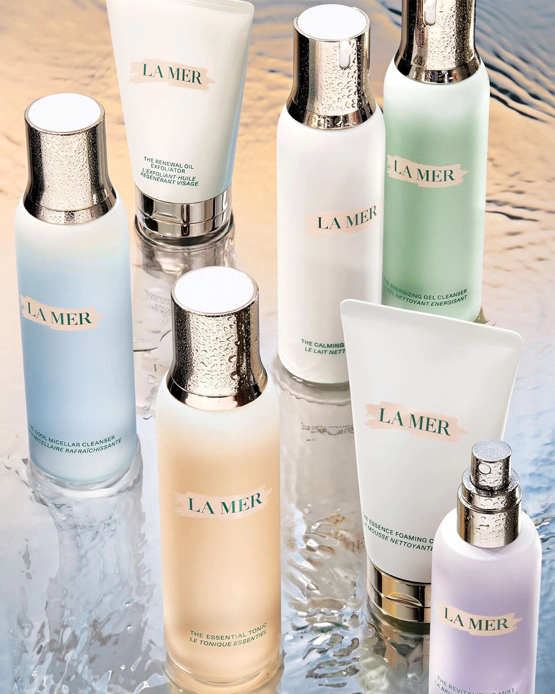 Collection of La Mer skincare products on a reflective surface