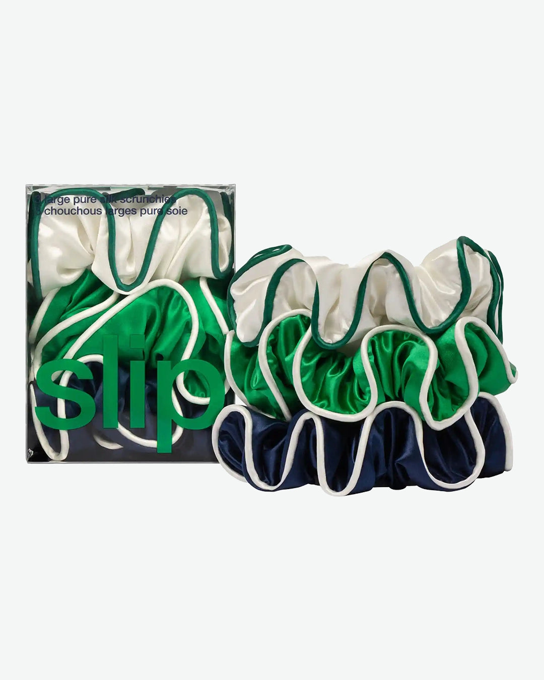 Set of green and navy hair scrunchies with packaging on a white background