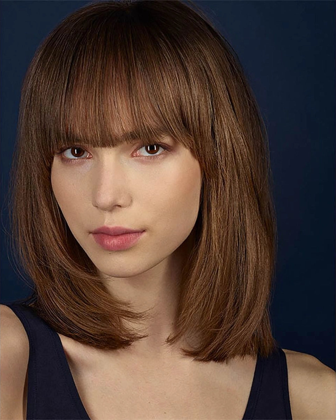 Woman with a stylish haircut against a dark background