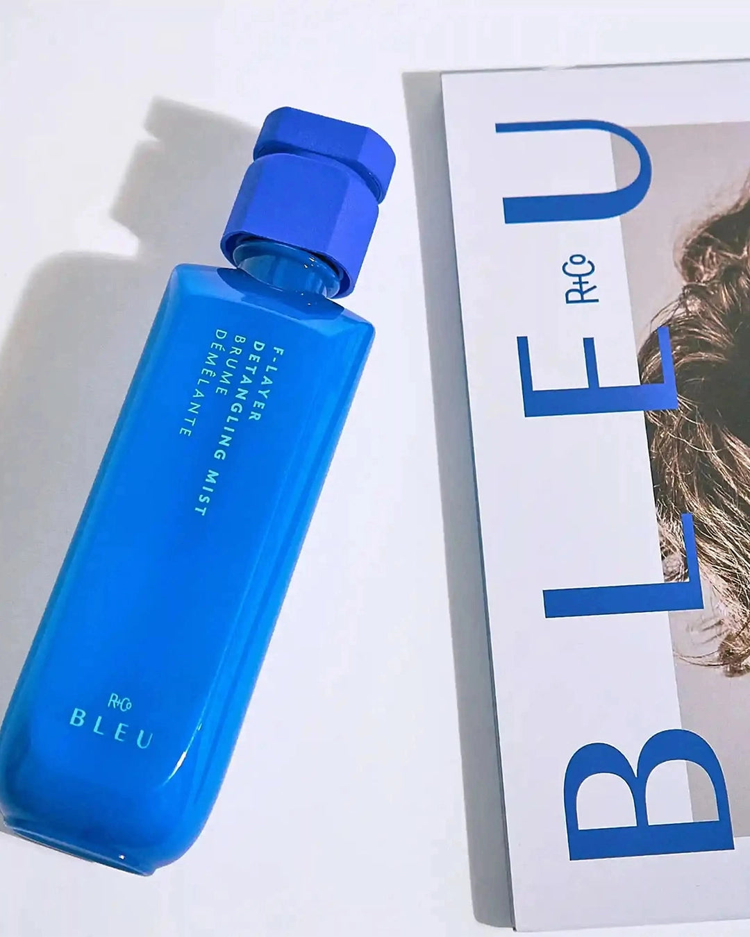 Blue bottle of Ro Bleu detangling mist on a white background