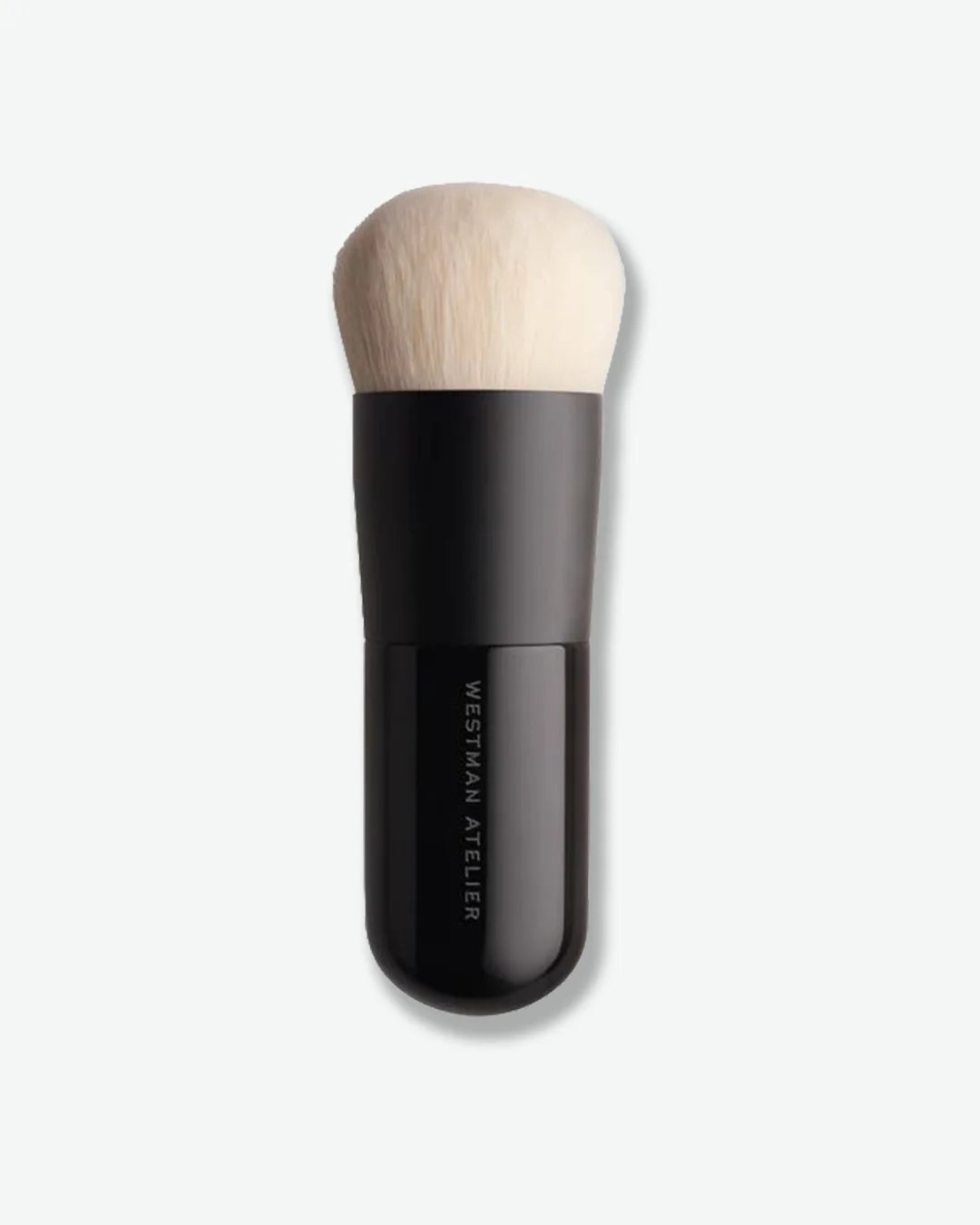 Makeup brush with black handle and wooden tip on a white background