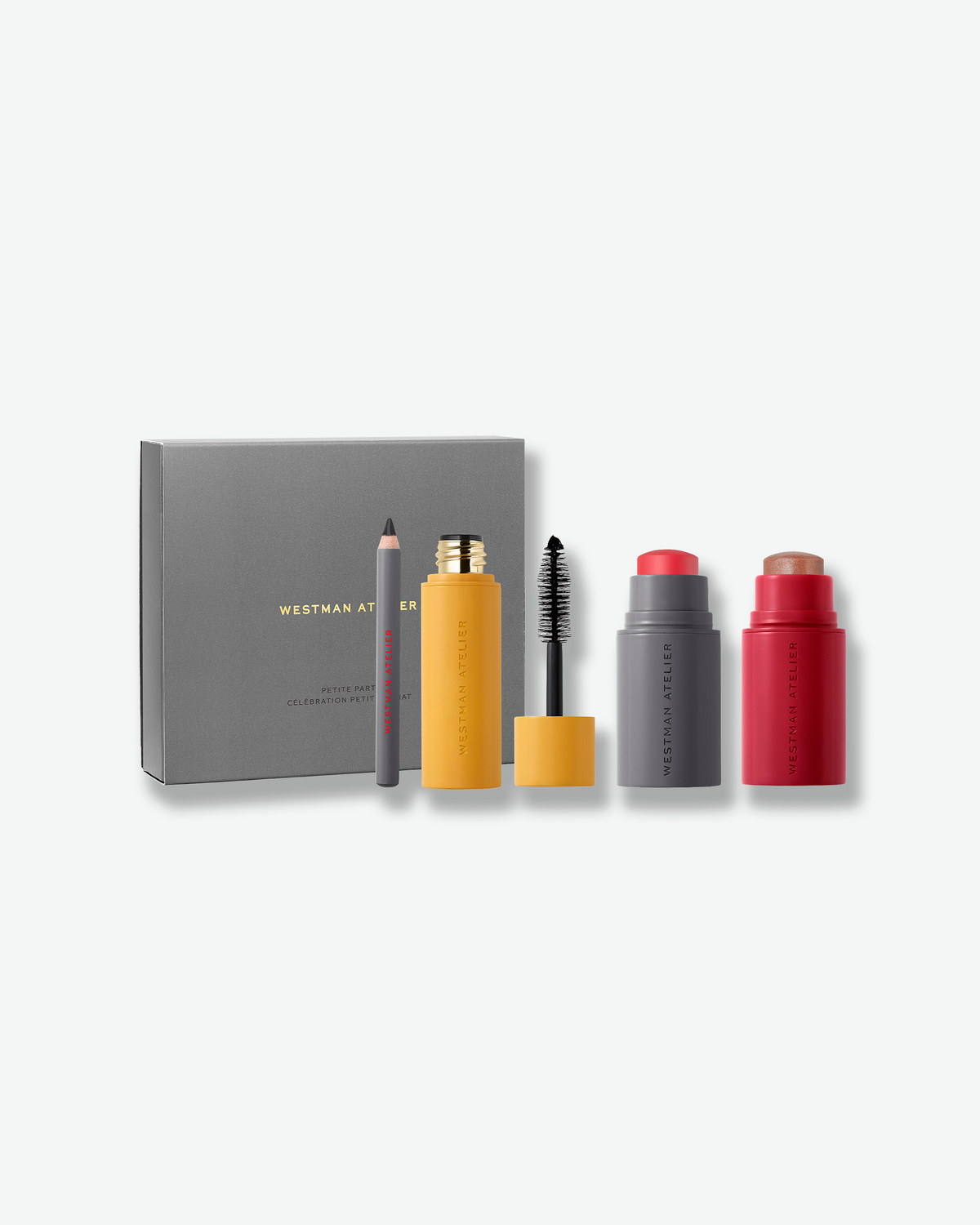 Westman Atelier Petite Party gift set with mini Baby Cheeks Blush Stick, Lit Up Highlight Stick, Eye Love You Eye Pencil, and Eye Want You Mascara alongside the grey gift box.