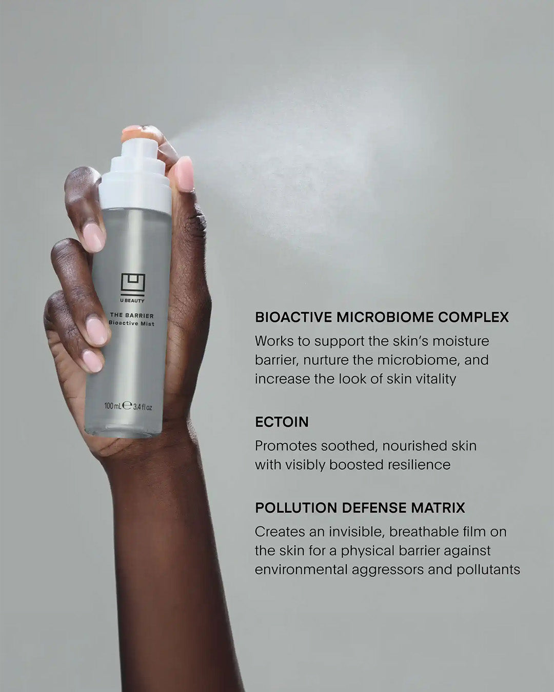Hand holding a skincare product with text about its benefits on a gray background