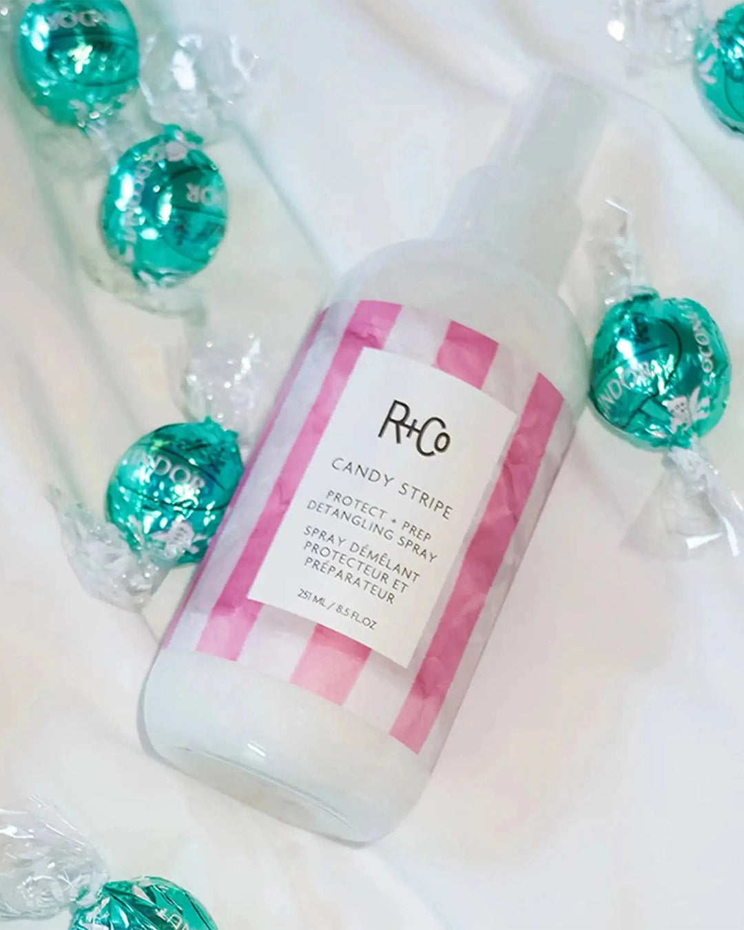 R+Co Candy Stripe hair product bottle with pink label on a white background