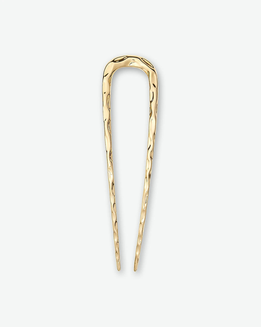 A textured, u-shaped gold hair pin shown vertically against a plain light gray background.