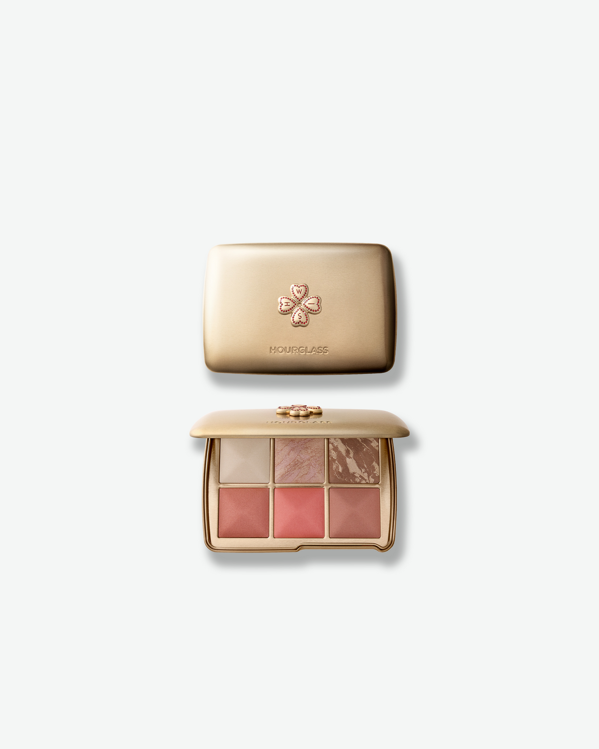 Hourglass Ambient Lighting Edit – Unlocked Palette in Wish, shown closed and open in a gold compact with six soft, luminous complexion shades and the decorative Wish clover emblem.