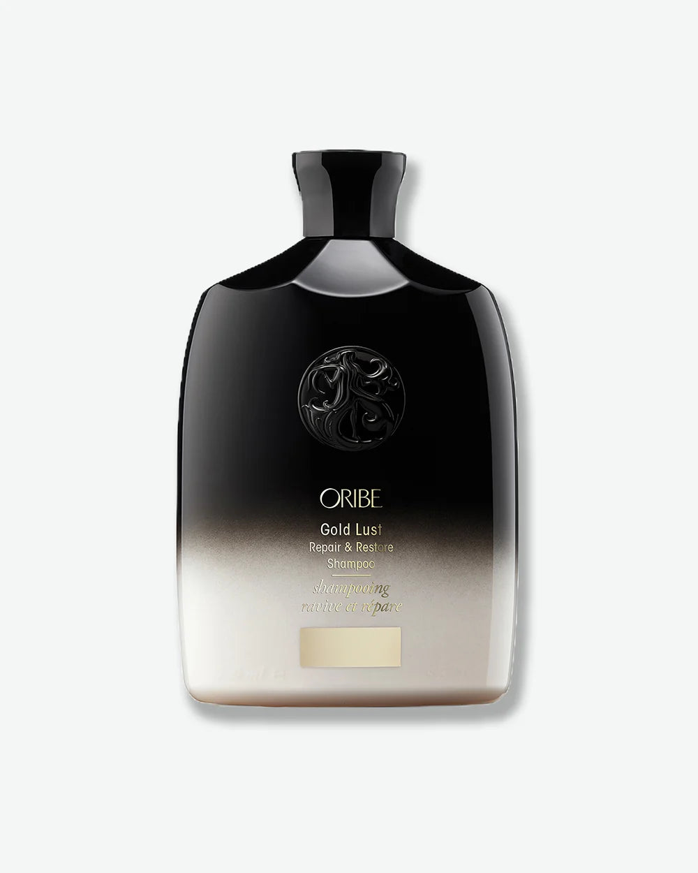 Oribe Gold Lust Repair & Restore Shampoo in a black-to-ivory gradient bottle with gold detailing.
