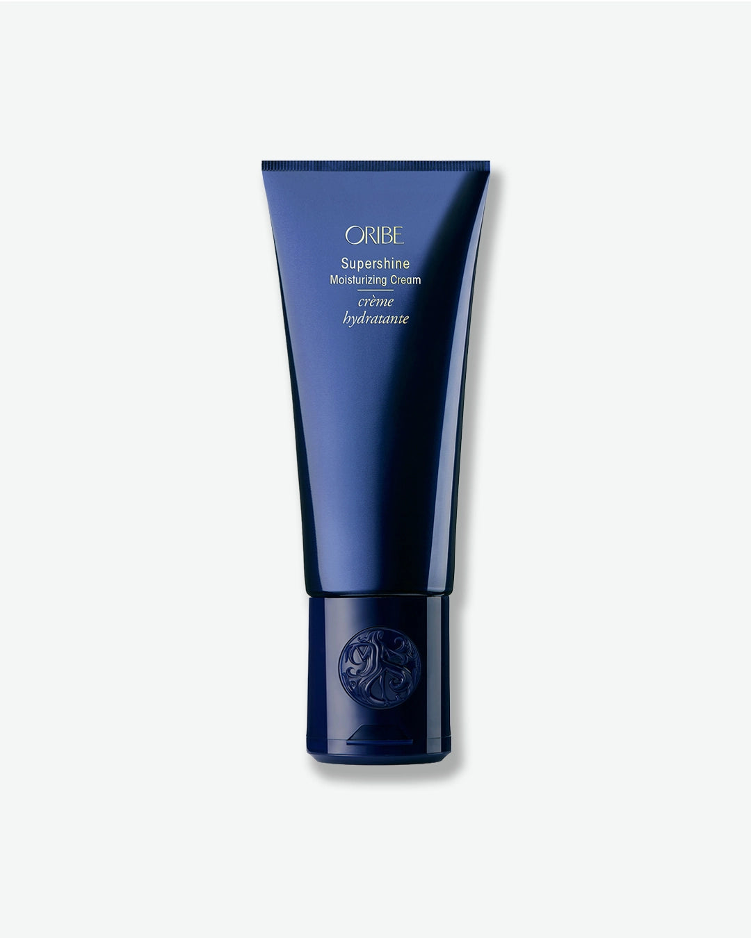 Blue tube of Oribe Superfine Moisturizing Creme on a white background