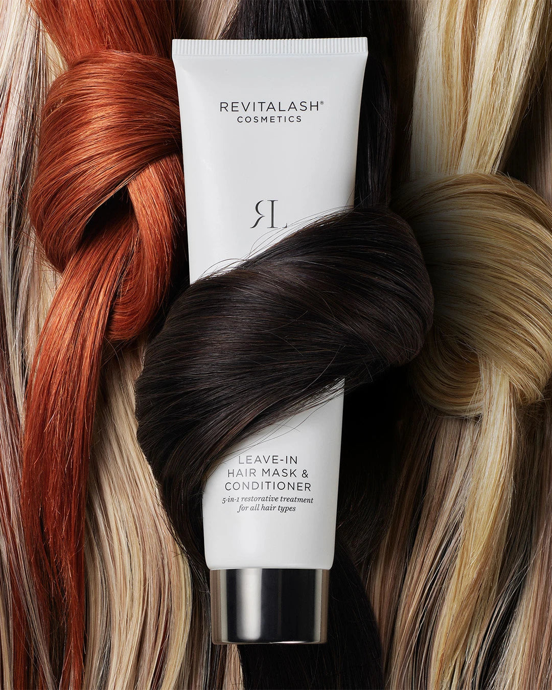 Revitalash hair care product with multicolored hair strands in the background