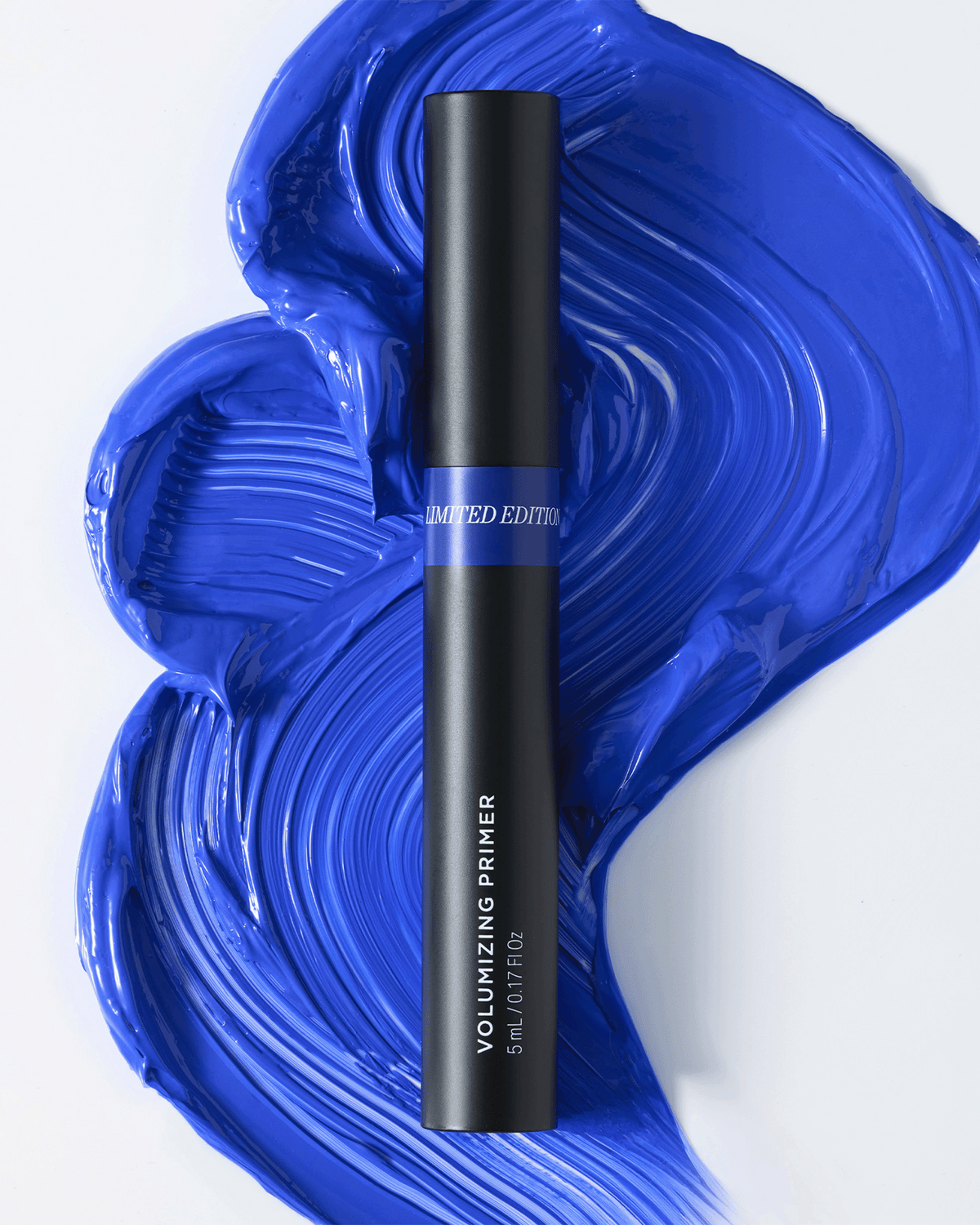 RevitaLash limited-edition Volumizing Primer tube displayed against a bold cobalt blue product swatch.