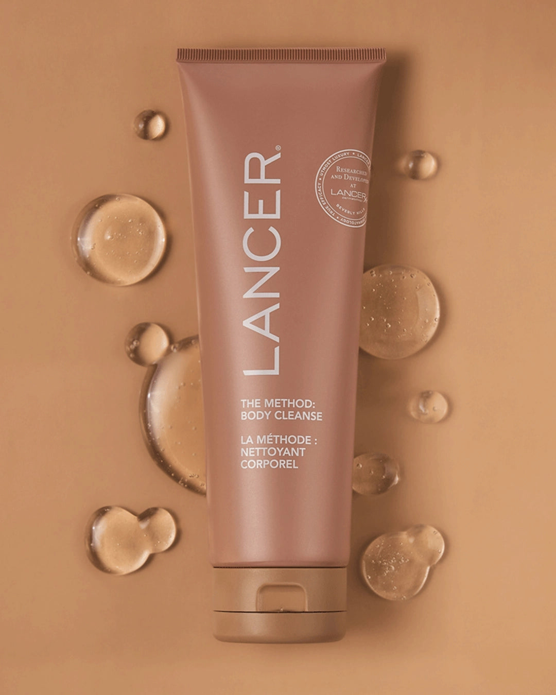 Lancer skincare tube on a beige background with water droplets