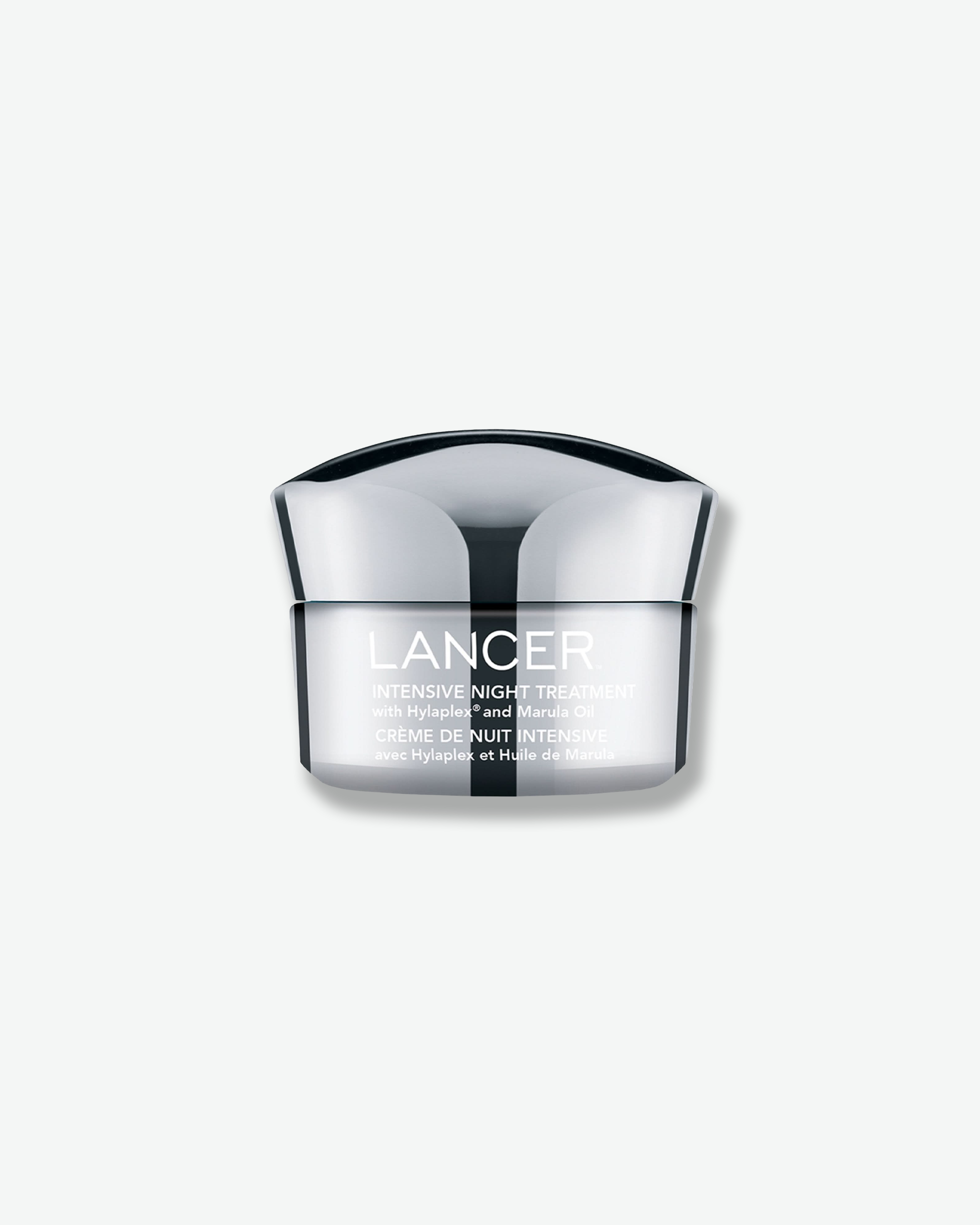 Front view of a Lancer Intensive Night Treatment jar against a plain gray background. The sleek cosmetic container features an opaque white base with silver-grey text detailing the formulation with Hylaplex and Marula Oil, crowned with a sculpted chrome metallic cap.