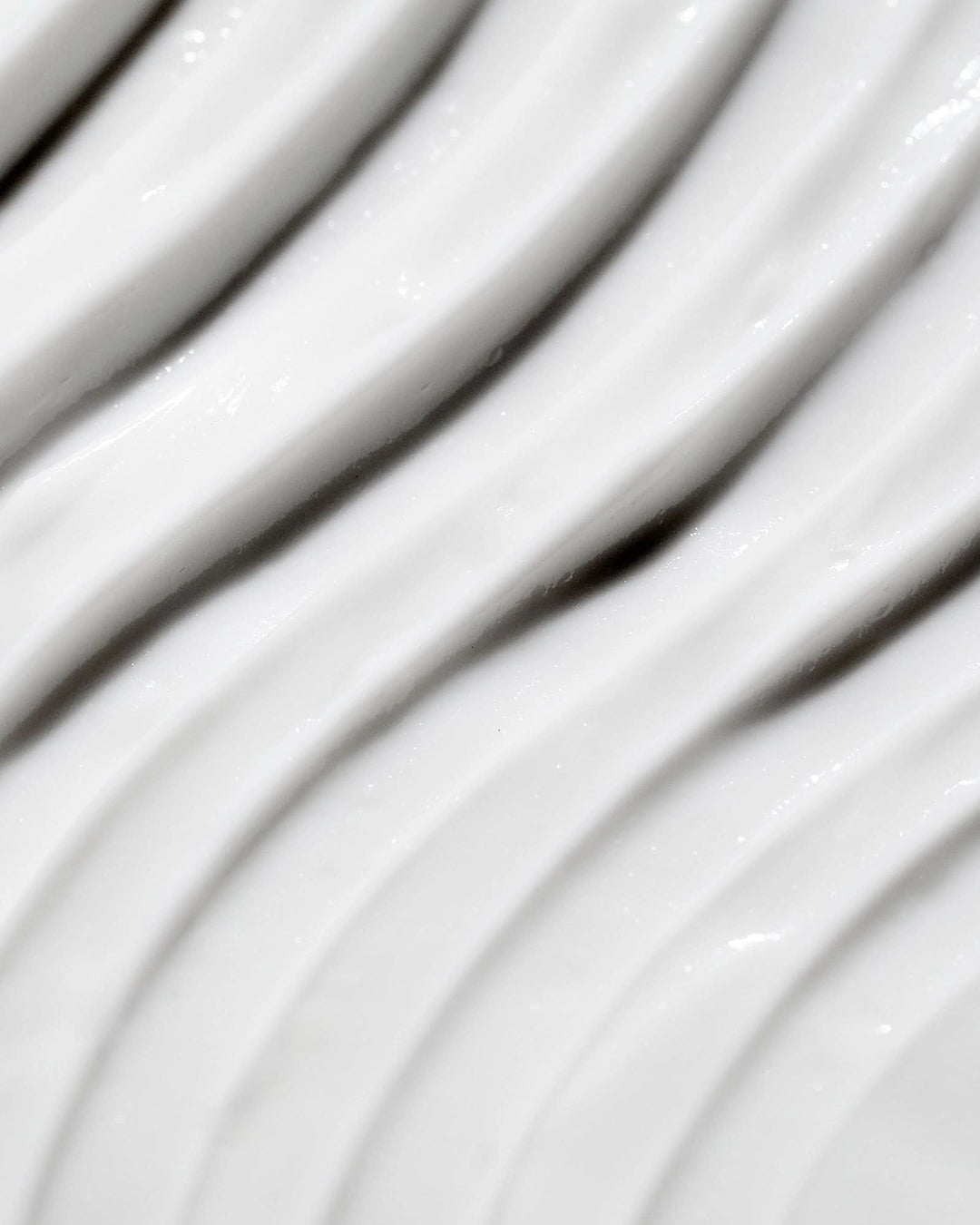 Close-up of white cream texture with wavy lines