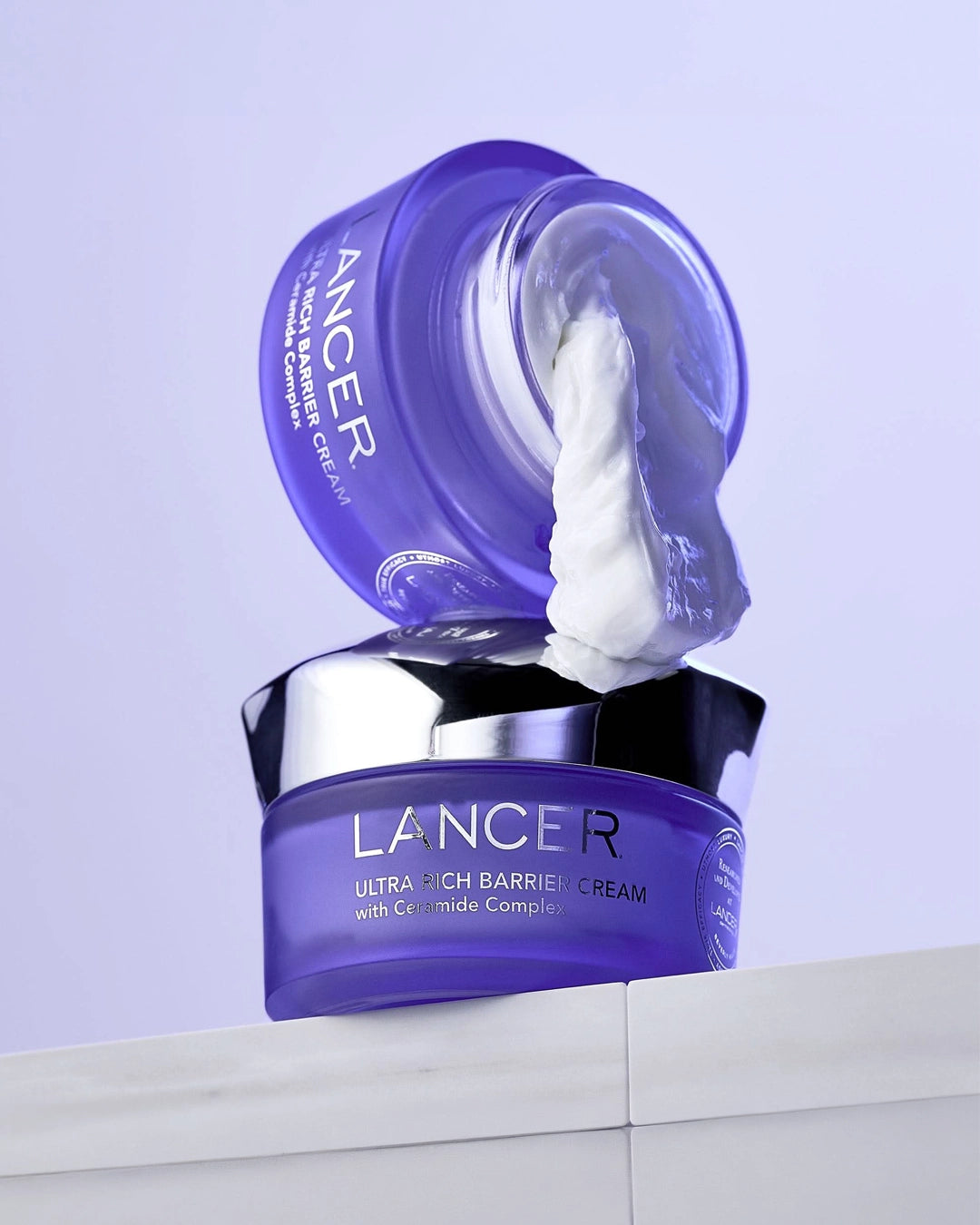 Lancer Ultra Rich Barrier Cream with a purple jar and white cream on a light gray background