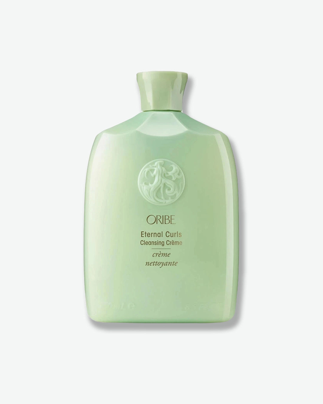 Green bottle of Oribe Eternal Curls Cleansing Crème on a white background