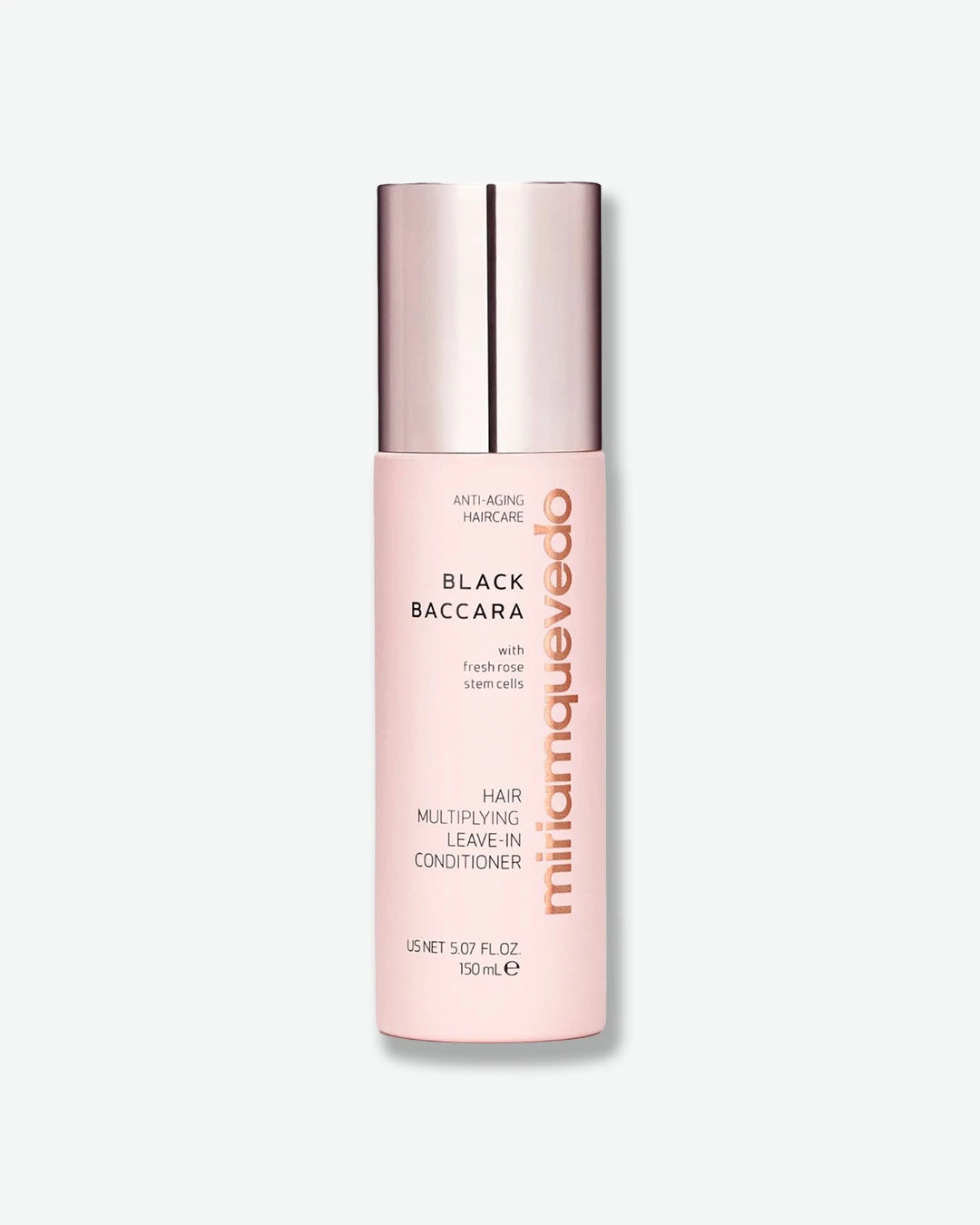 Pink bottle of Miriam Quevedo hair product on a white background