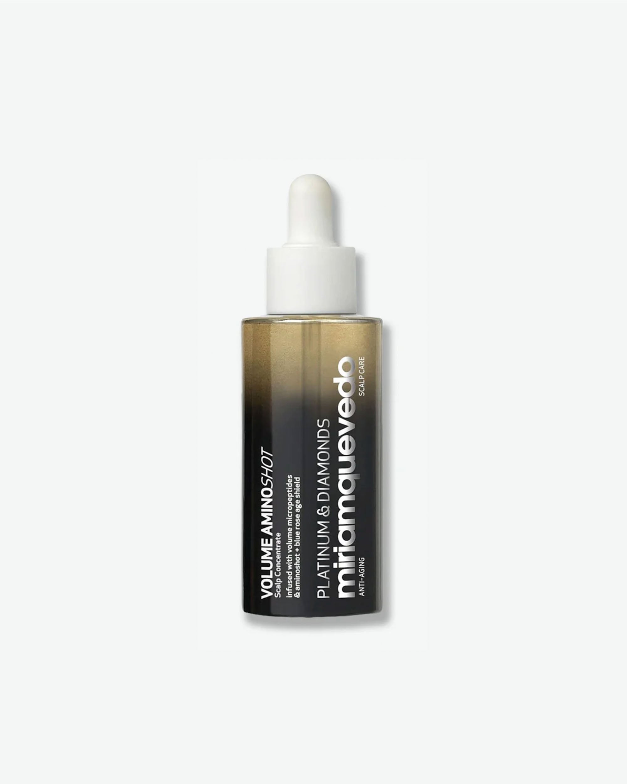 A vertical product shot of Miriam Quevedo Platinum & Diamonds Volume Aminoshot Scalp Concentrate. The bottle features a modern gradient transition from a clear, golden-hued liquid at the top to a solid black base. It is topped with a white dropper cap assembly and features vertical white typography detailing the brand and product line name.
