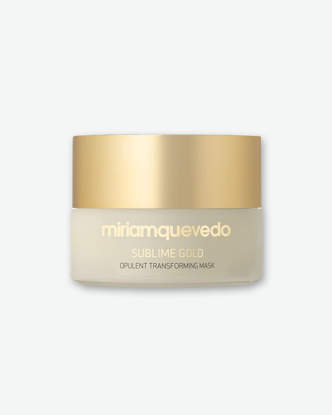 A product shot of a Miriam Quevedo Sublime Gold Opulent Transforming Mask jar, centered against a plain light gray background. The low, wide-mouthed frosted glass jar reveals a pale, cream-colored formula inside. It is sealed with a smooth, brushed-gold screw cap. The front displays the brand name "miriamquevedo" along with "SUBLIME GOLD" and "OPULENT TRANSFORMING MASK" in matching clean gold text.