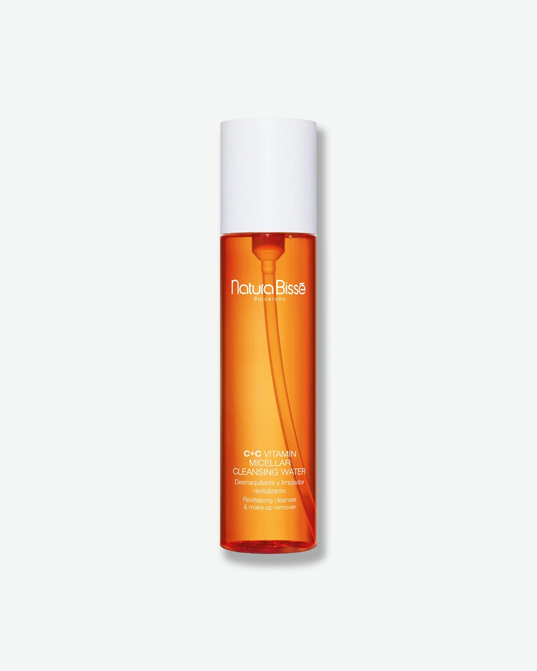 Orange bottle with white cap labeled 'Natura Bissé' on a light gray background