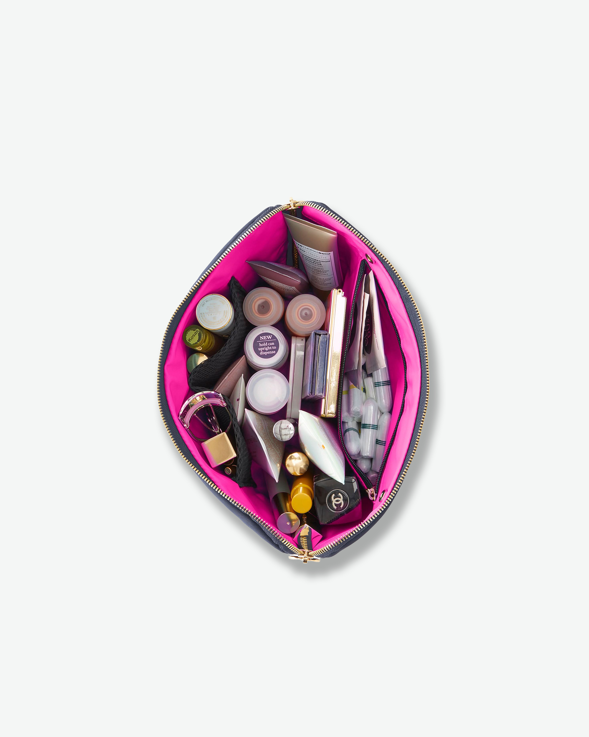 An open teardrop-shaped makeup bag filled with various cosmetics, shown from a top-down view on a light gray background.